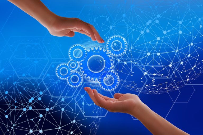 Two hands holding interacting gears that represent data on a blue background overlaid with a matrix representing data.