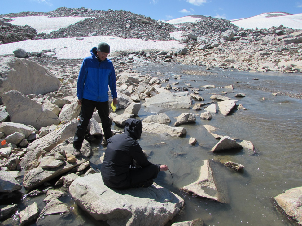 Dr. Greg Vandeberg and Robbie MacDonald sampling water quality at the outlet stream of Continental Glacier.
