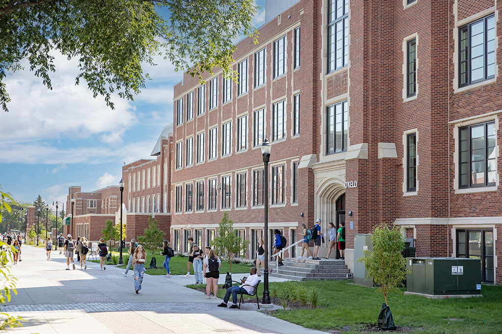 Students walking past and into O'Kelly Hall