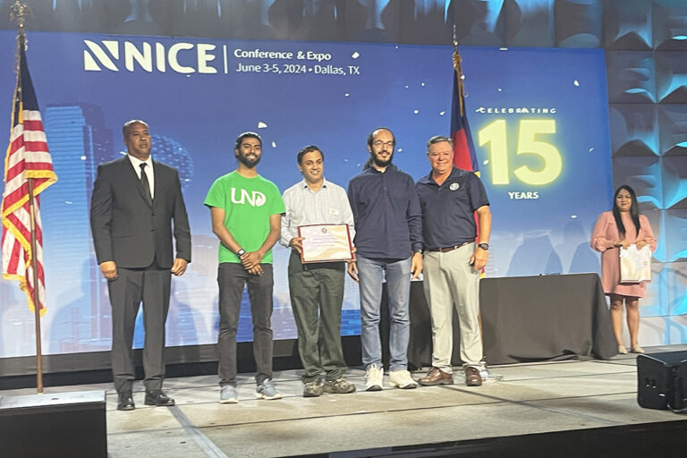 Prakash Ranganathan and students hold certificate on stage