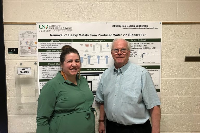 Beth Klemenstrud and Wayne Seames stand in front of research poster