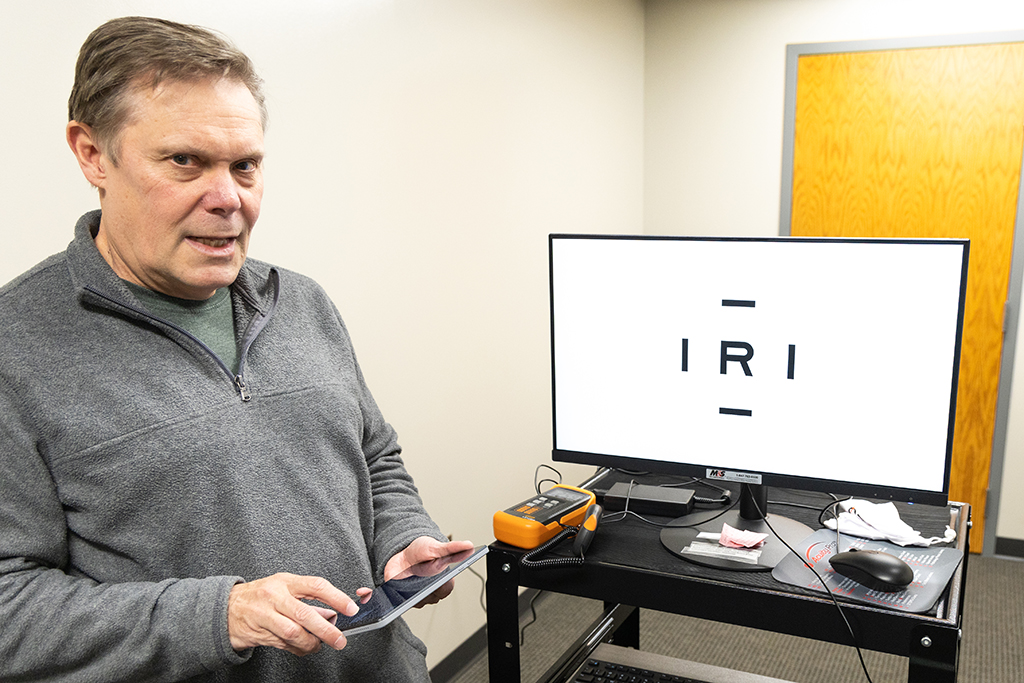 Dr. David Biberdorf in front of eye test screen