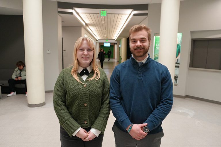 Caroline Kelly and Zachary Hoff standing together in Odegard Hall