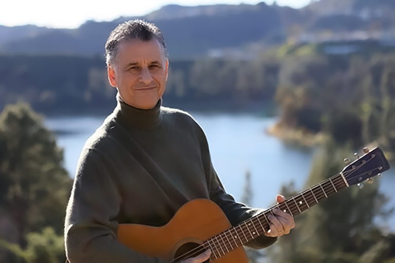 Portrait of Dr. Daniel Levitin with guitar.