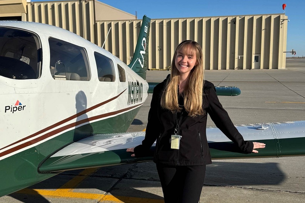 Sarah Hines stands by UND single-engine aircraft at Grand Forks International Airport.