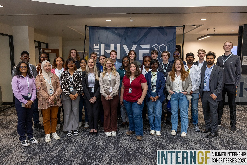 Group of interns pose for photo in The Hive in downtown Grand Forks