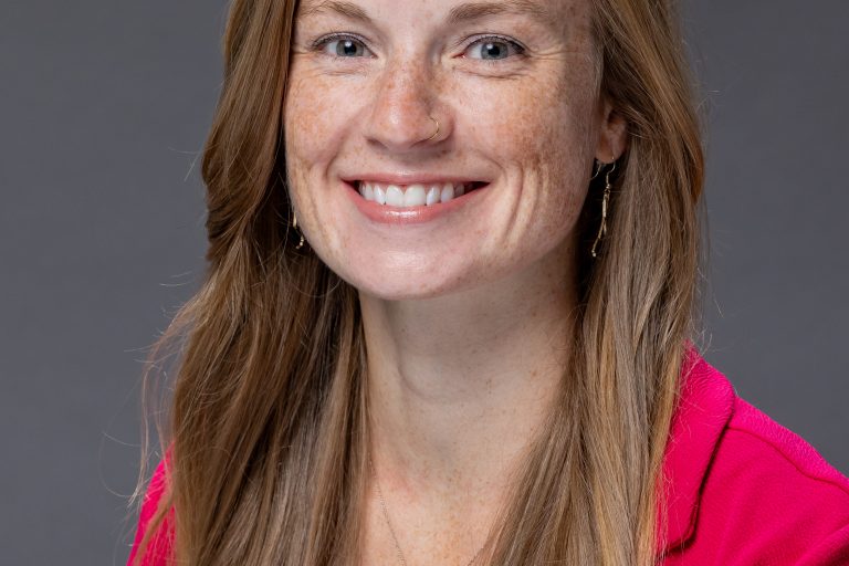 A professional headshot of a woman