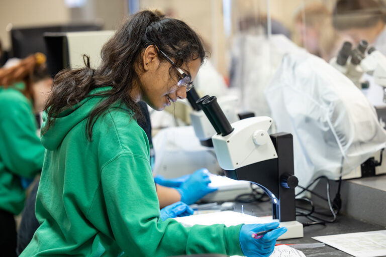 student at microscope