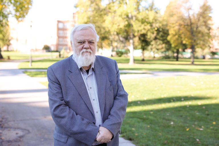 Chuck Haga standing on campus