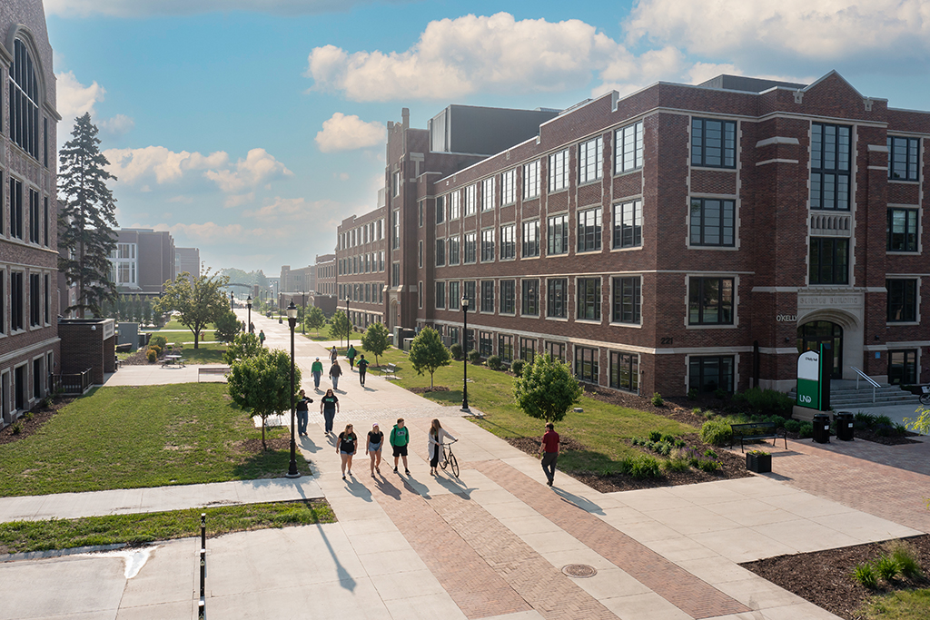 Aerial view of students walking through campus corridor on sunny day