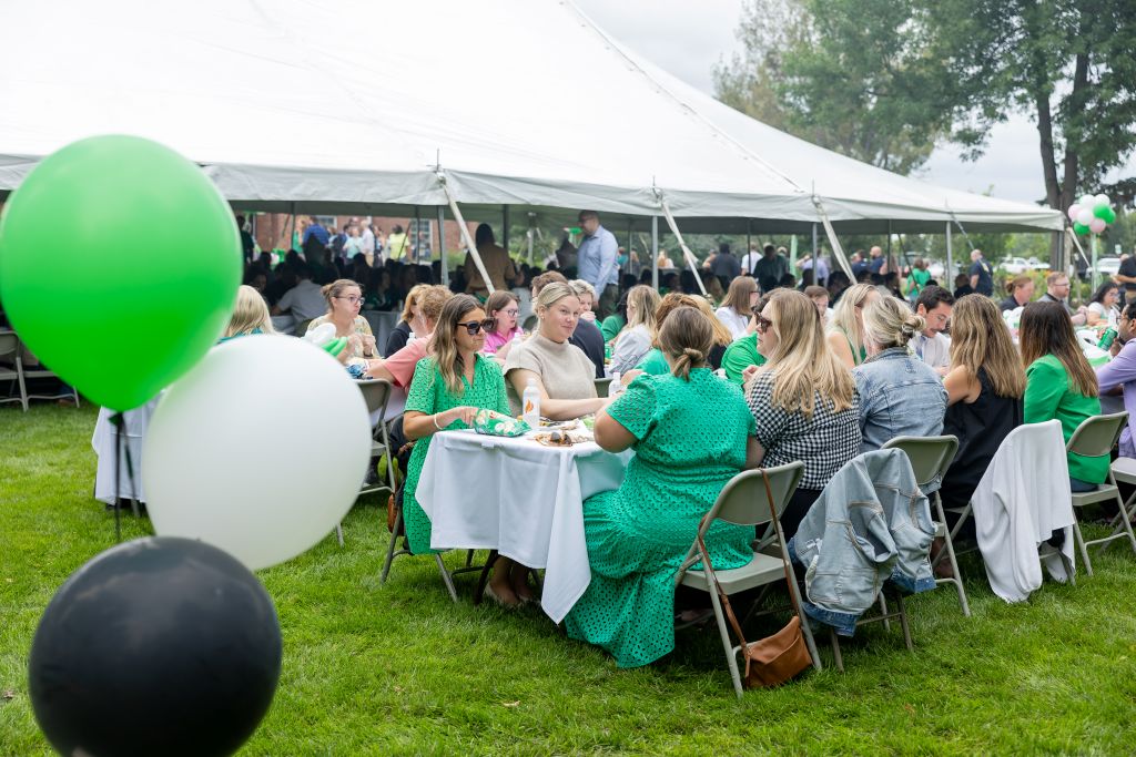 Large group gathered at tables during picnic