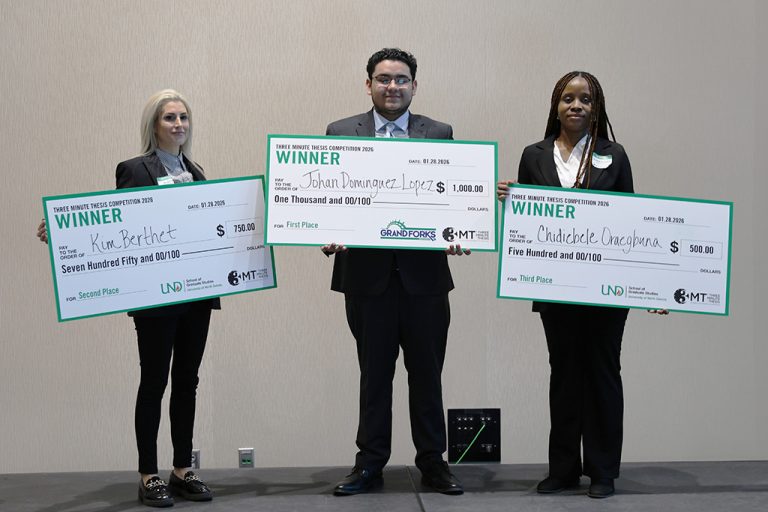 From left to right, Kim Berthet, Johan Dominguez Lopez and Chidiebele Oraegbuna holding large checks