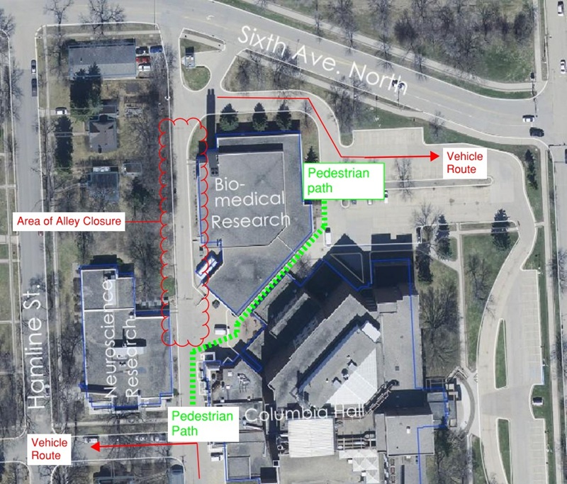 Map showing area of alley closure with a pedestrian detour indicated to the east of the biomedical research building and vehicle detours indicated through the east parking lot and west to Hamline Street.