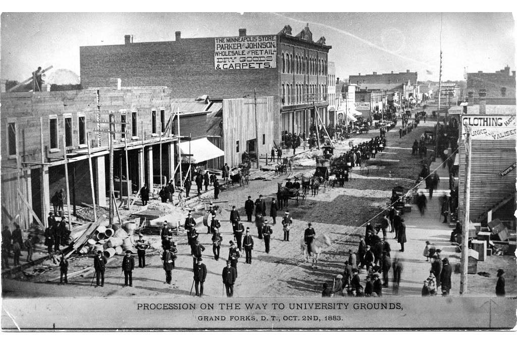 historic photo of an 1883 procession at UND