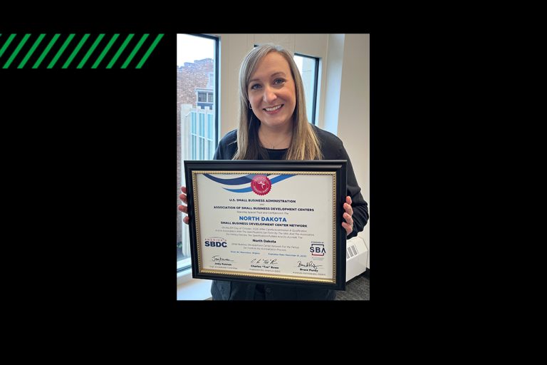 Tiffany Ford holding certificate of accreditation