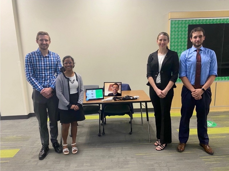 From left are Sam Dressler, Big Lake, Minn.; Jasmyn Loven, Bismarck, N.D.; Daryl Johnson (attending remotely, on screen), Solon, Ohio; Megan Larson, Jamestown, N.D.; and Jack Neis, Devils Lake, N.D., the UND seniors who designed and built a functioning, prosthetic partial hand. Photo courtesy of UND College of Engineering & Mines.