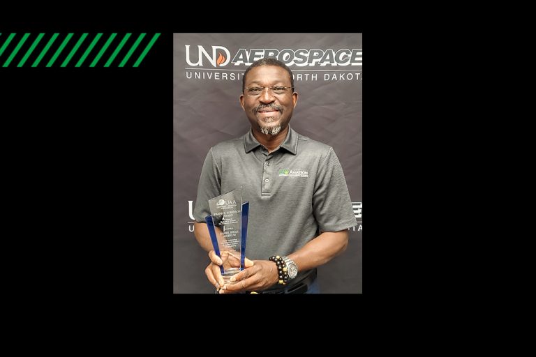 Daniel Adjekum holding award