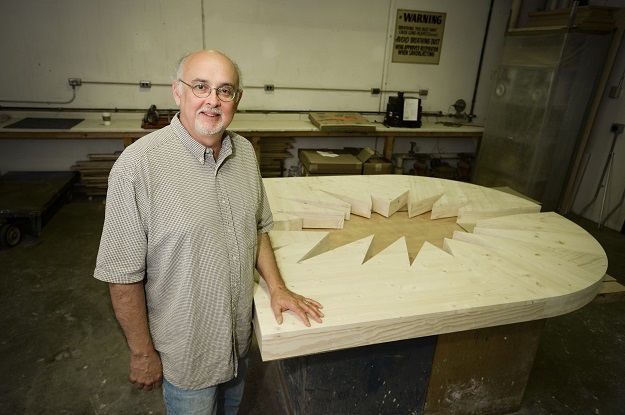Patrick Luber standing by his 13 x 13 sculpture