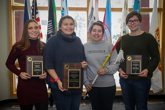 Members of UND’s American Indian Science and Engineering Society chapter earned several honors at the Society’s most recent conference in Minneapolis. A few of the members pose for a group picture as they hold the chapter’s national awards from 2015 and 2016. (left to right) Cheyenne Defender, Dunseith, N.D.; Hannah Balderas, New Town, N.D.; Emily Falcon, Belcourt, N.D.; and Makayla Platt, Tacoma, Wash. Photo by Shawna Schill.