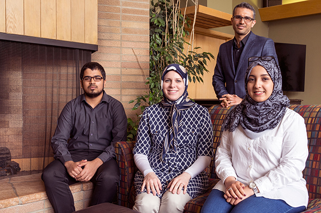 (Left to Right) Bailey Bubach, faculty and professional advisor for petroleum engineering from Grand Forks; Rehan Ali Mohammed, petroleum engineering master’s student from Hyderabad, India; Maram Al-Sayaghi, a chemical engineering doctoral student from Sana’a, Yemen; and Mehdi Ostadhassan, assistant professor of petroleum engineering, a native of Iran. Photo by Richard Larson. 