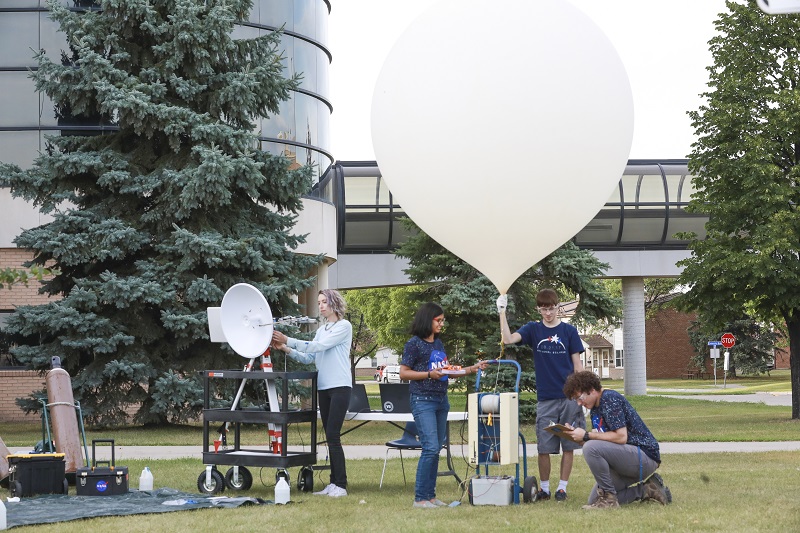 Denise Buckner (left) leads the high altitude balloon test launch as Anamika, Lance Wilson and Peter Henson prepare equipment. They will send live video and still feeds from Idaho during the Aug. 21 eclipse. The North Dakota Space Grant Consortium is participating in the National Eclipse Ballooning Project.
