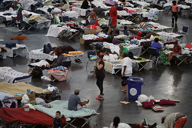People take shelter at one of hundreds of hurricane shelters set up throughout Texas after flood waters from Hurricane Harvey inundated towns and cities on Aug. 29 in Houston, Texas. Getty Images.