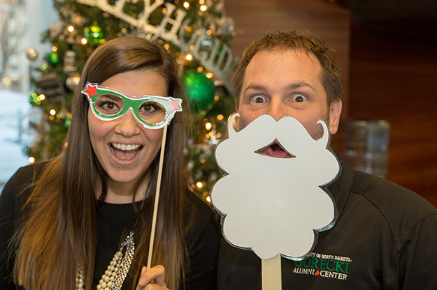 Keeley Gregoire and Sam Melquist with the UND Alumni Association worked to make the annual Holiday Cheers party a "go-to" event. Photo by Milo Smith, UND Alumni Association & Foundation