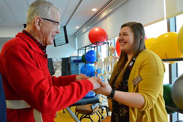 Ron Mack of East Grand Forks worked with third-year physical therapy student Carmen Stanhope at the pro-bono physical therapy clinic last fall at the School of Medicine &amp; Health Sciences. Photo by Wanda Weber/School of Medicine &amp; Health Sciences