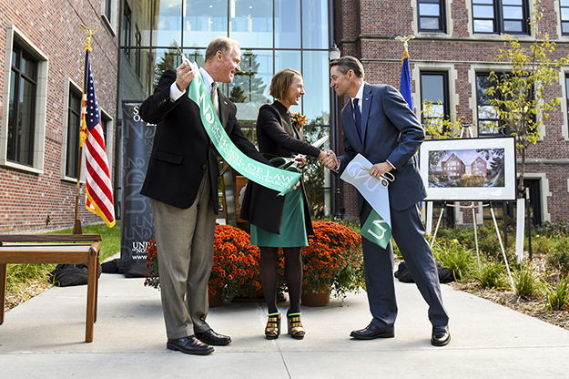 Rand (center) cuts the ribbon on the addition and renovation to the School of Law with former UND President Robert Kelley and then North Dakota lieutenant governor and UND alum, Drew Wrigley. Image courtesy of Rob Carolin.