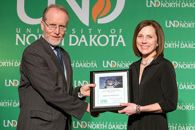 University System Chancellor Mark Hagerott presents the UND Foundation/B.C. Gamble Faculty Award for Excellence in Teaching, Research or Creative Activity, and Service to Daphne Pedersen (Sociology) at the 2018 Founders Day celebration on Feb. 22. Photo by Jackie Lorentz/UND Today.