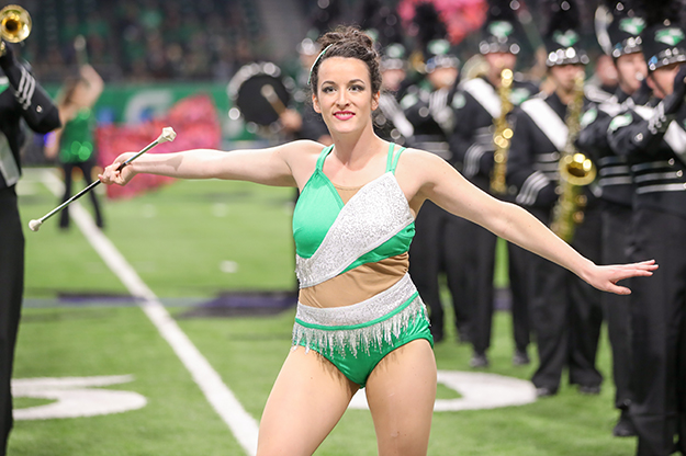 Stephanie Paro, twirler for the Pride of the North Marching Band, transferred to UND after four years in the Navy that took her around the world. Now she's pursuing a nursing degree while advancing her talents as a majorette. Photo by Shawna Schill/UND Today.