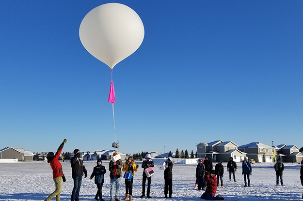 Participants in the Near-Space Balloon Competition, representing 10 different schools around the state, launch payloads on the tail of a high-altitude balloon, Saturday. It’s the culmination of months-long projects conducted by middle and high schools with the assistance of North Dakota Space Grant Consortium, who are based at UND. Two balloons carried student-made experiments almost 20 miles into the sky, past 99% of Earth’s atmosphere. Image courtesy of North Dakota Space Grant Consortium.
