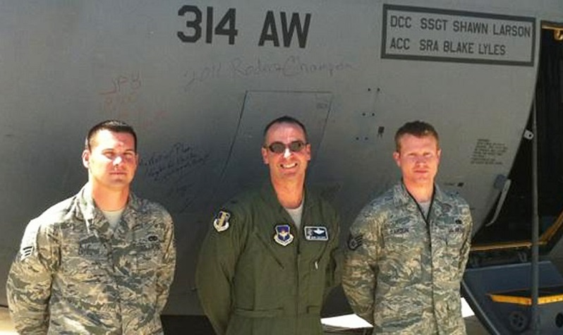 Crew Chief Shawn Larson (right), Assistant Crew Chief Senior Airman Blake Lyles (left) and Wing Commander Colonel Mark Czelusta pose for one last photo after the decision was made to retire their plane. Photo courtesy of Shawn Larson.