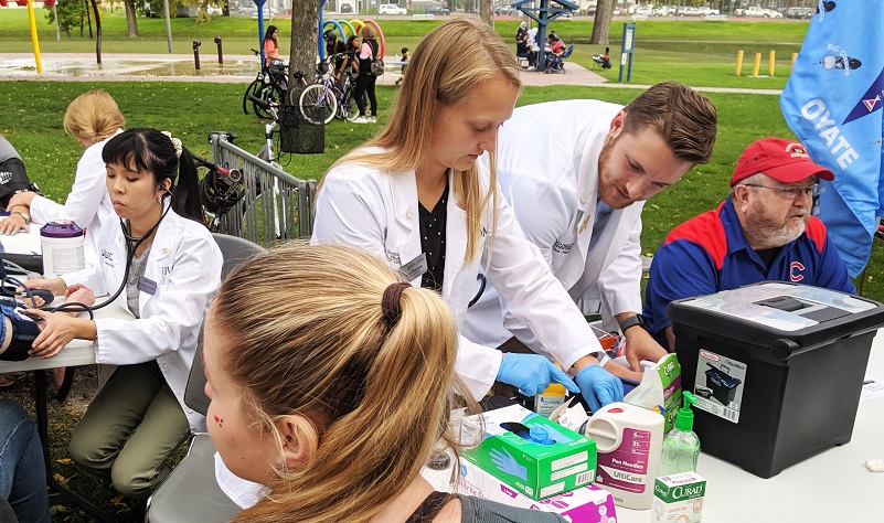 UND medical students, led by Dr. Eric Johnson, held a free clinic at a picnic in University Park last September. Photo courtesy of UND School of Medicine & Health Sciences.