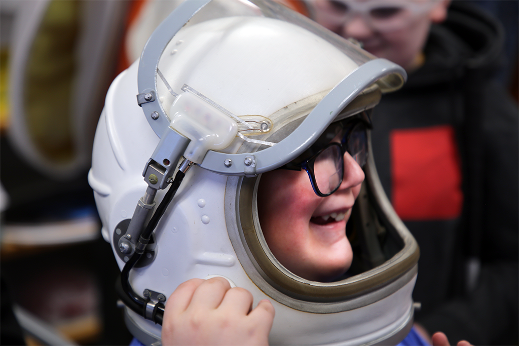 student wearing space helmet