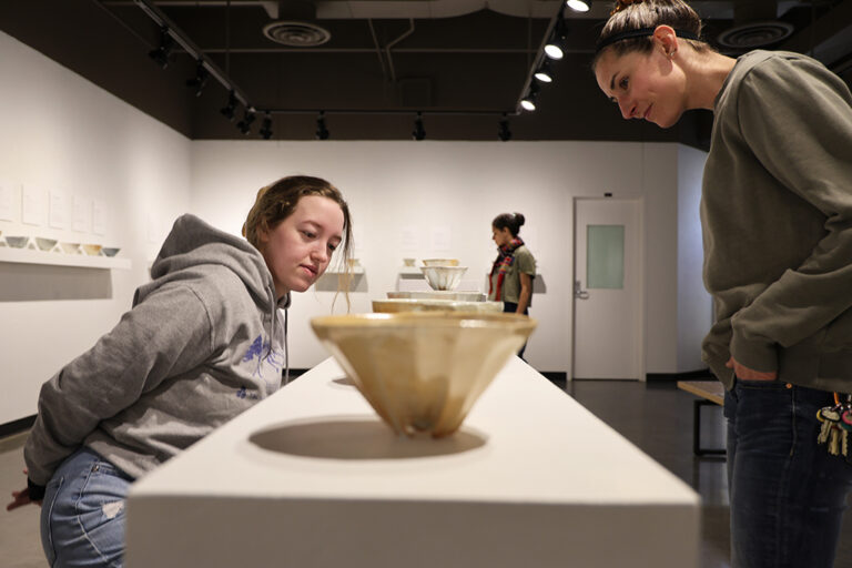 Women looking at ceramics in a gallery