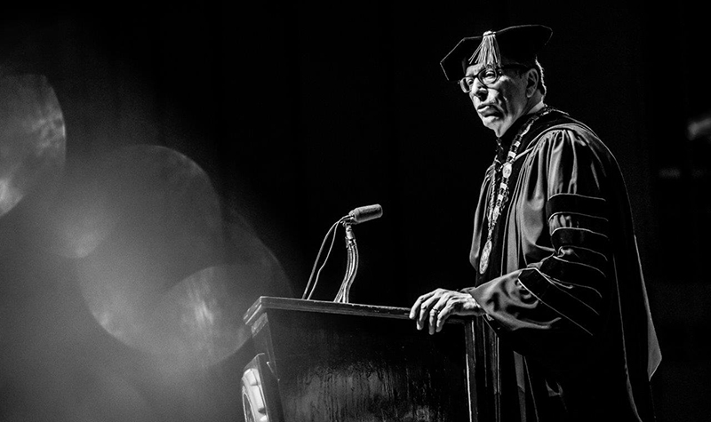 Joshua Wynne in commencement regalia