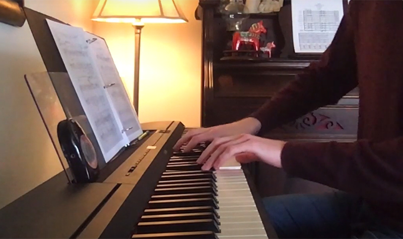 Person's hands on piano keys