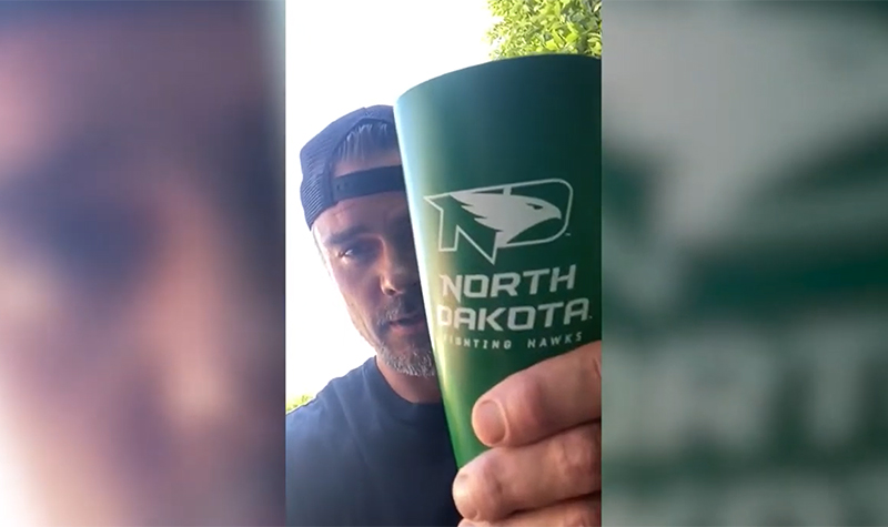 Josh Duhamel holds North Dakota fighting hawks cup