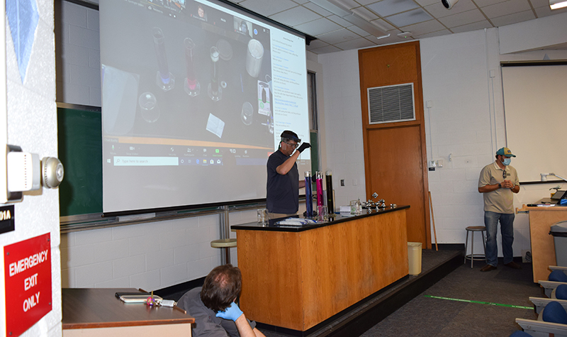 David Pierce conducts experiment at front of classroom