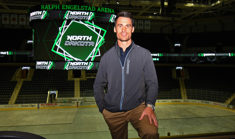 Brandon Bochenski with Ralph Engelstad jumbotron behind