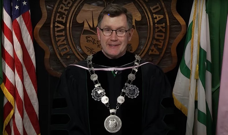 Andrew Armacost in commencement regalia