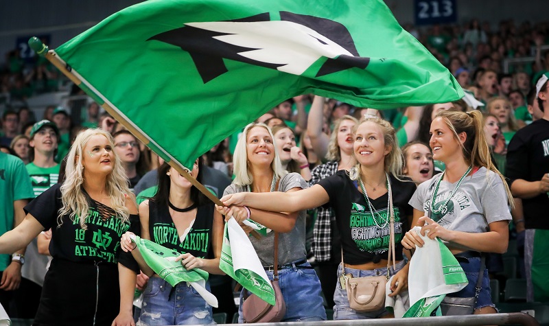 Student waves Fighting Hawks flag