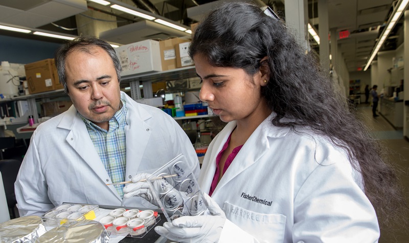 Colin Combs with student in lab