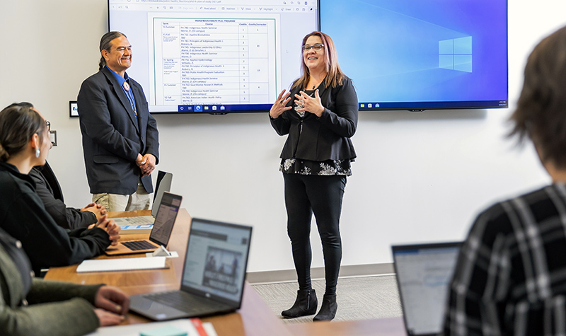 Melanie Nadeau with Don Warne in front of class