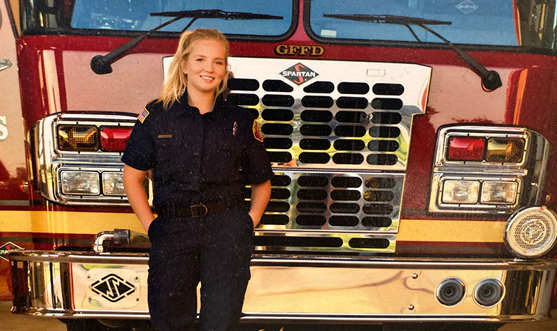 Miranda Olson standing in front of fire truck