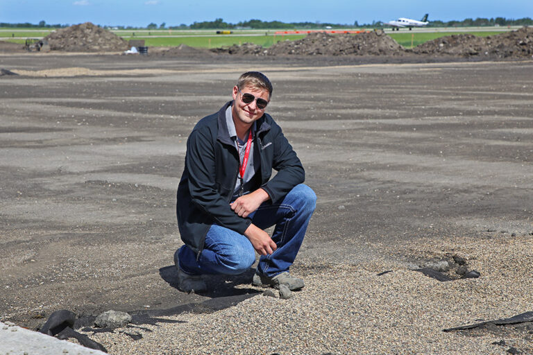 Patrick Casserly kneeling by gravel