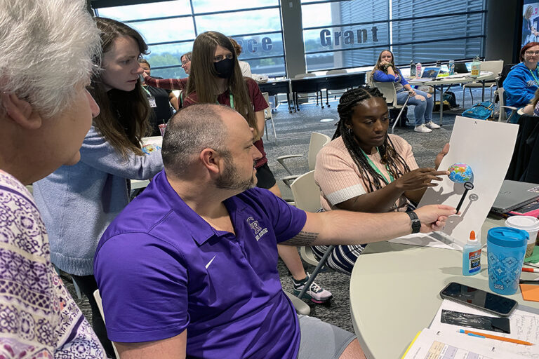 Teachers test tools explaining magnetic field