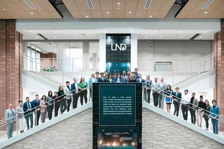 UND students, faculty and guests stand on Memorial Union staircase