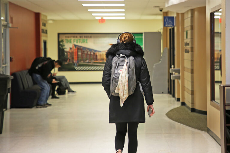 Student walking through Gamble Hall